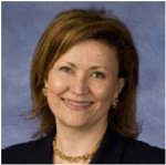 Professional woman with short brown hair smiling.