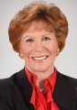 Professional portrait of an elderly woman with a warm smile.