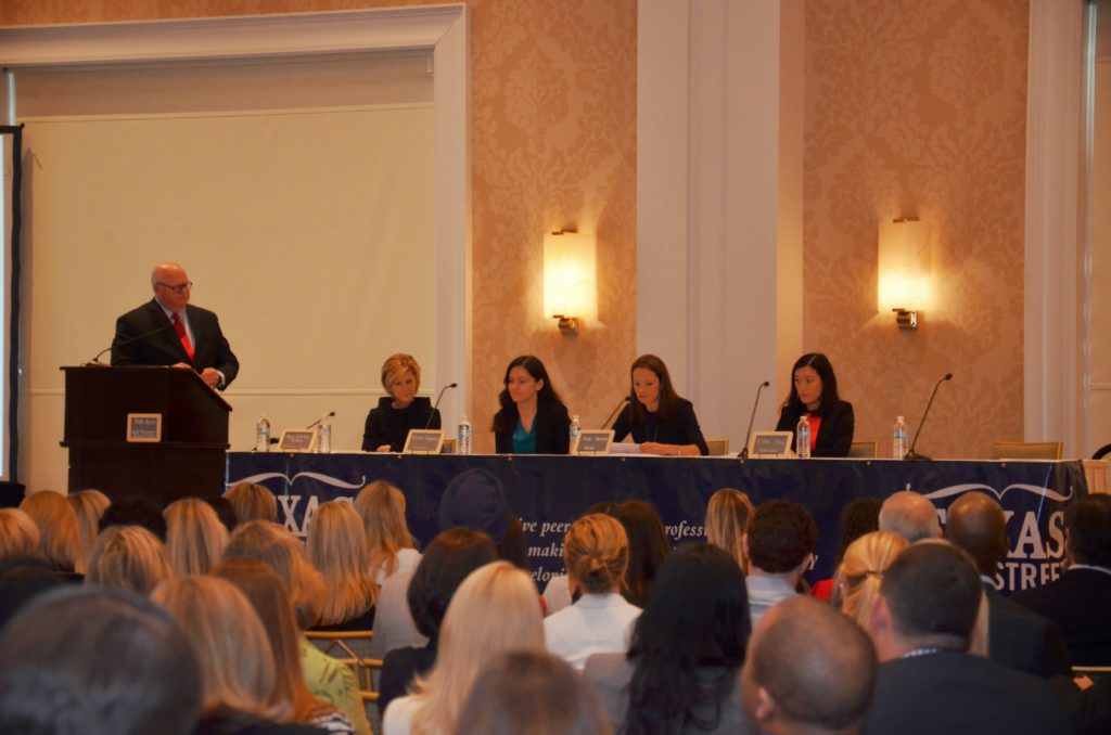 Panel discussion at a conference with an audience.