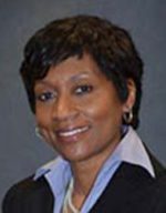 Professional portrait of a woman with short hair and a friendly smile.