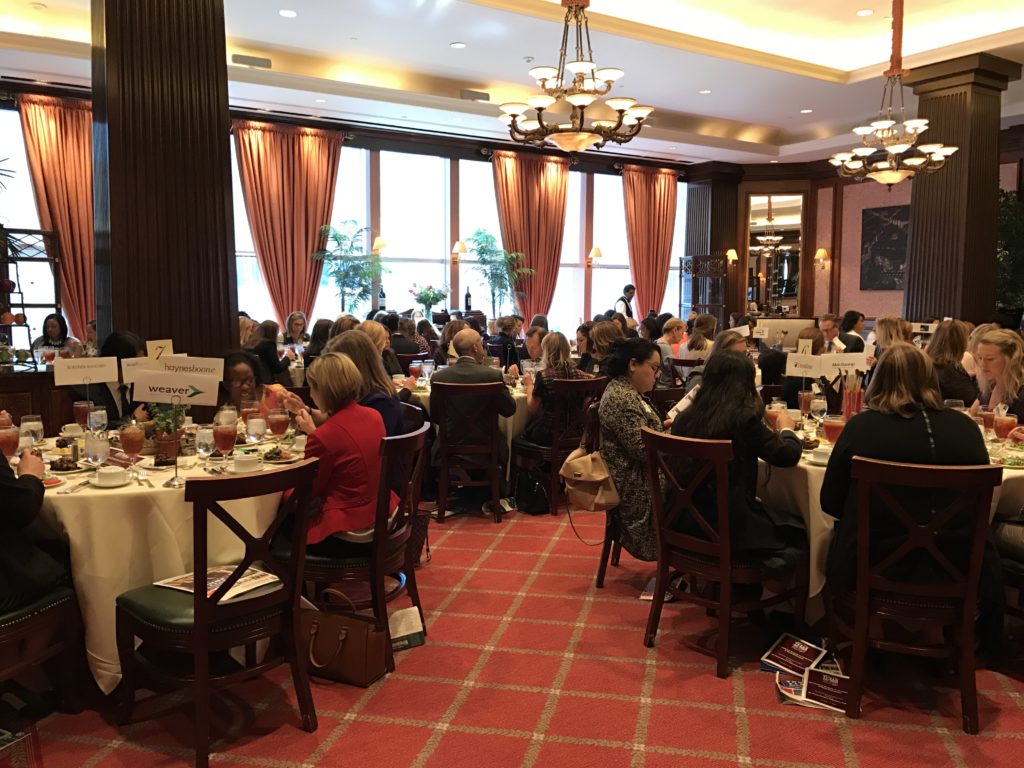 A crowded restaurant with people dining and socializing.
