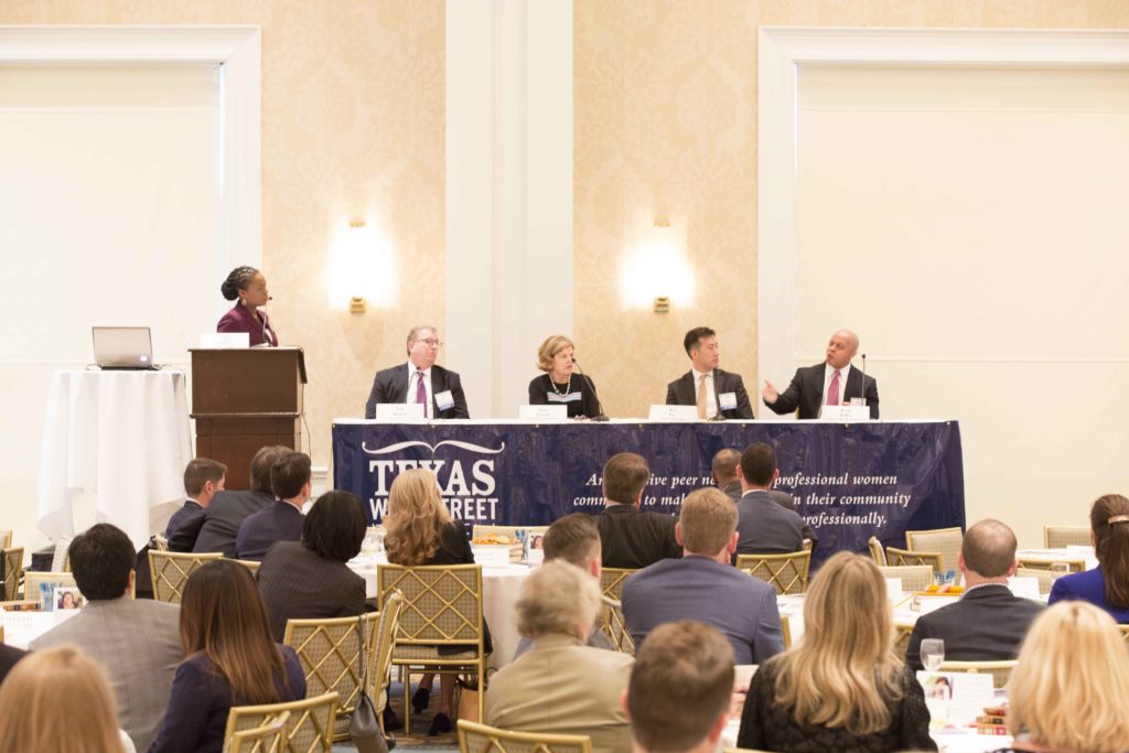 Panel discussion at a professional conference with audience members.