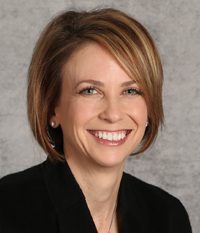 Professional woman smiling in a business portrait.