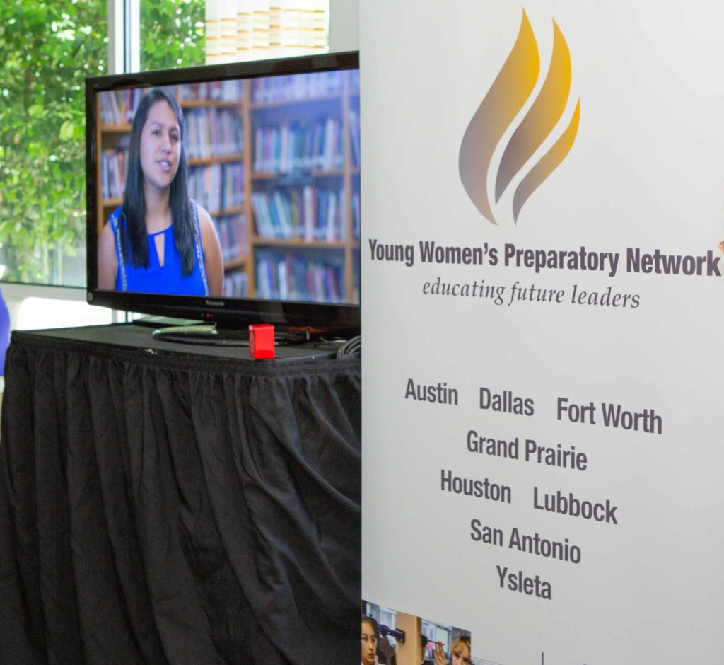A woman on TV with a banner for Young Women's Preparatory Network.