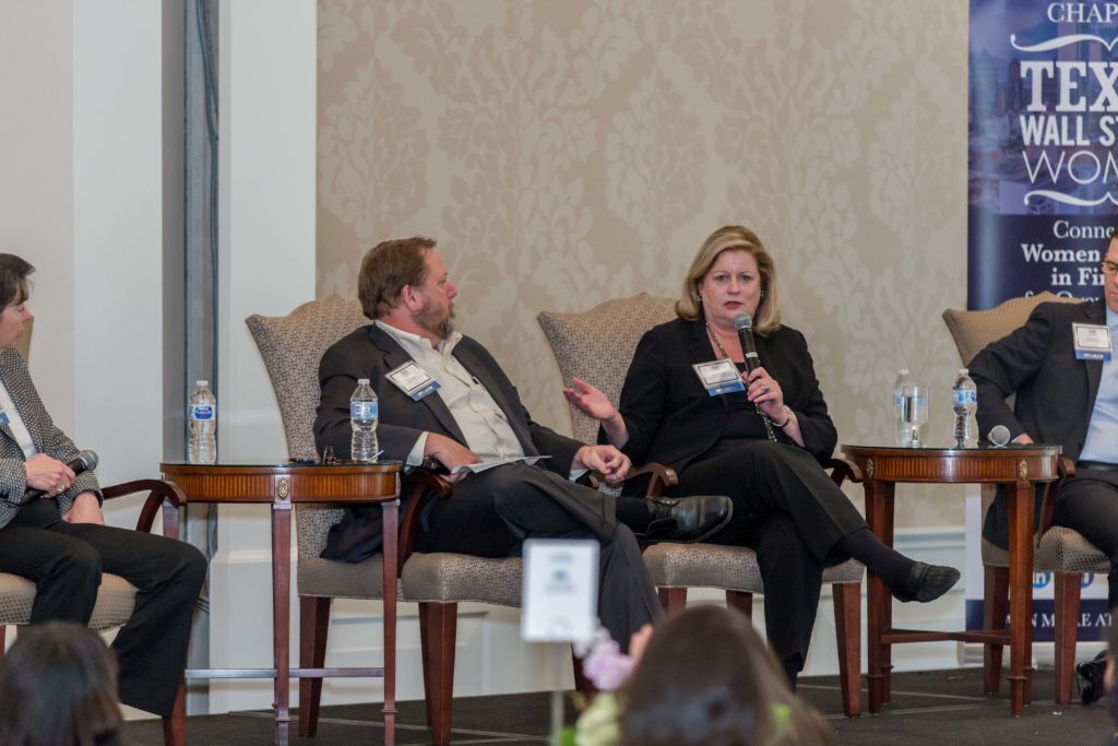 Two individuals engaged in a discussion during a formal event.