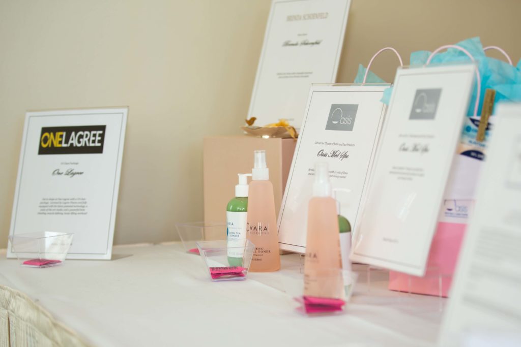 A table with pink-themed skincare products and informational cards.