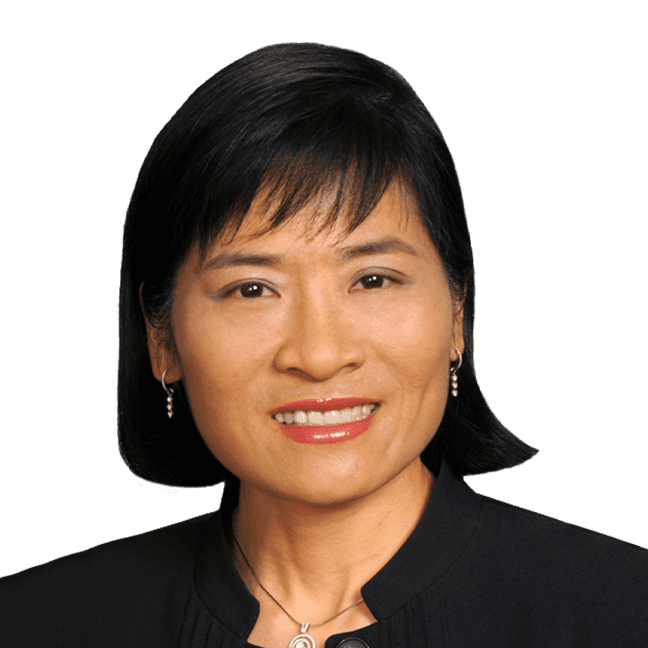 Portrait of a smiling woman with short black hair in a black blazer.