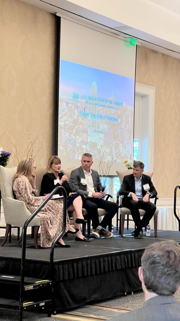 Panel discussion with four seated speakers.