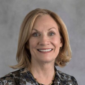 Smiling woman with short blonde hair.