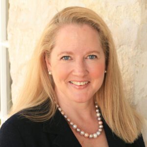 Smiling woman with long blonde hair.