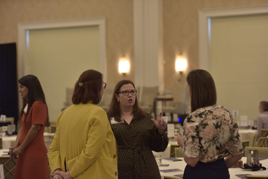 People conversing in a conference room.