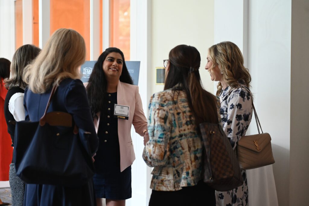 Group of women talking at an event.