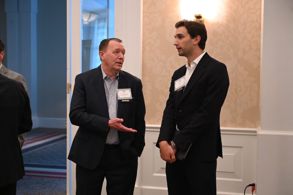 Two men talking at an event.
