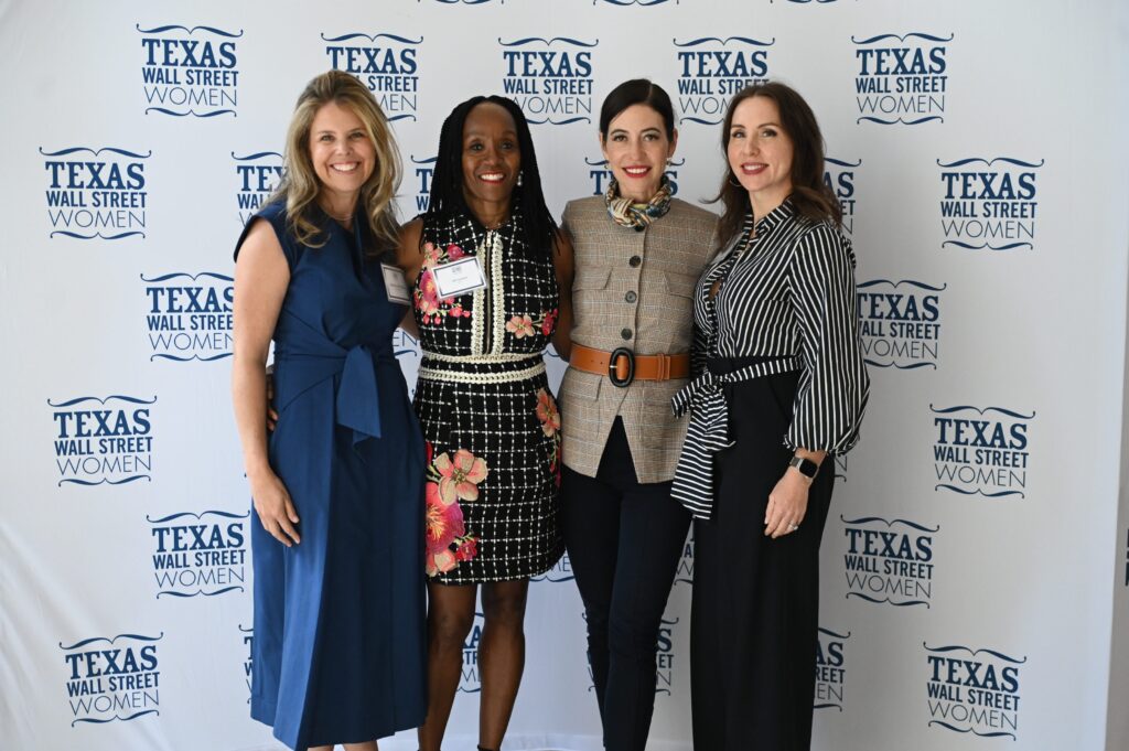 Four women posing at Texas Wall Street event.